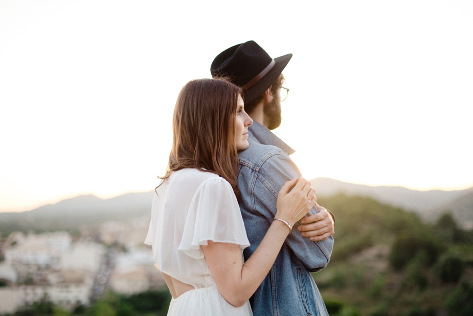 boho couple during sunset on hilltop