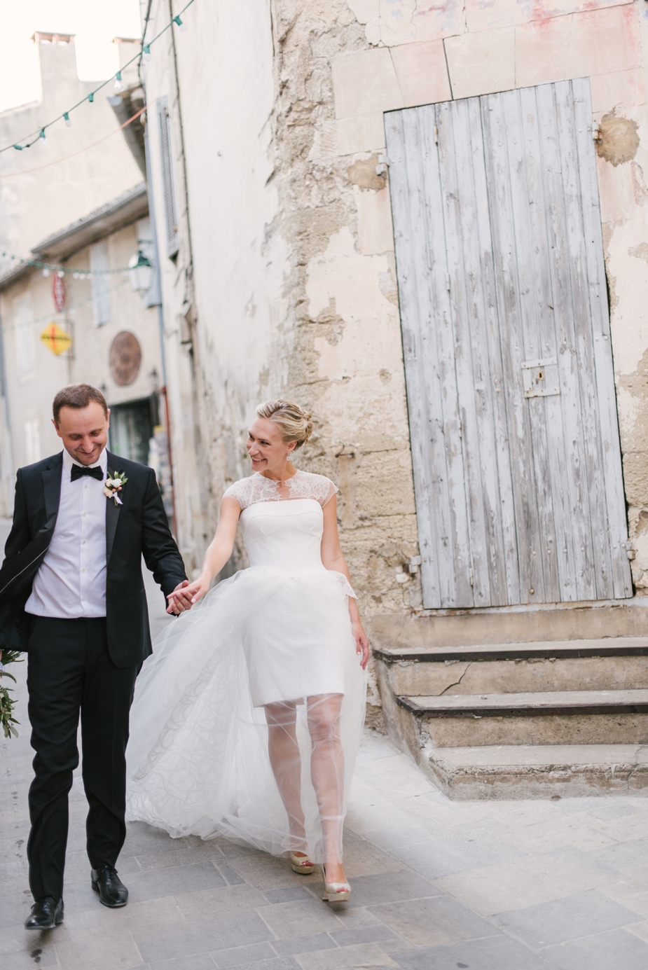bride and groom walking on the streets of Menerbes Provence